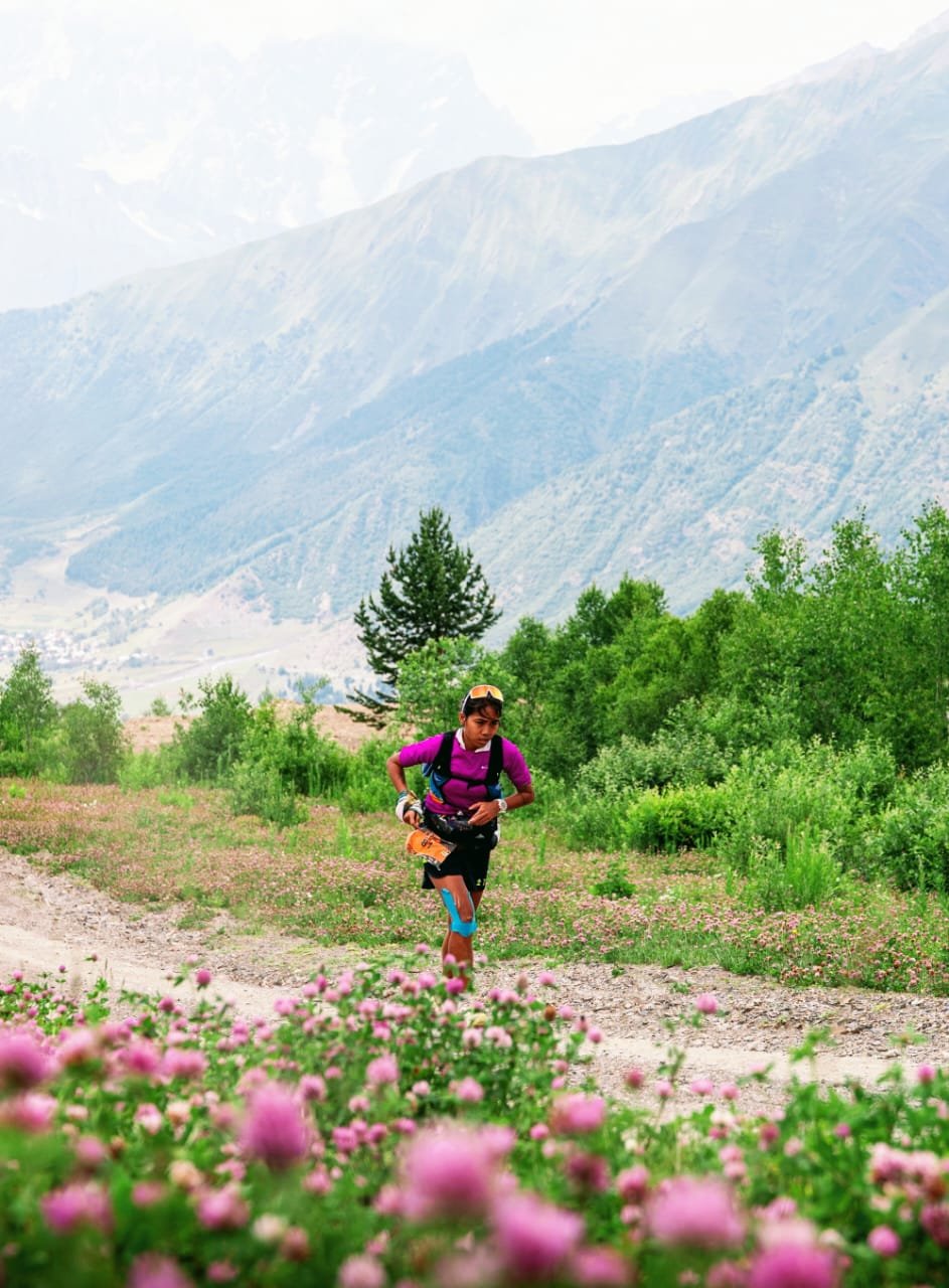Trisha trail running through a pink flower field