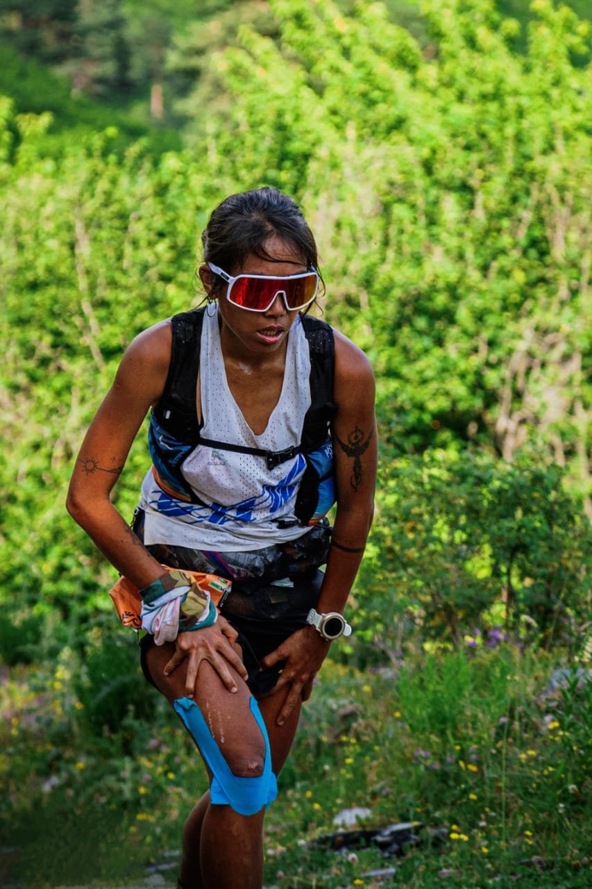 Trisha trail running through the forest